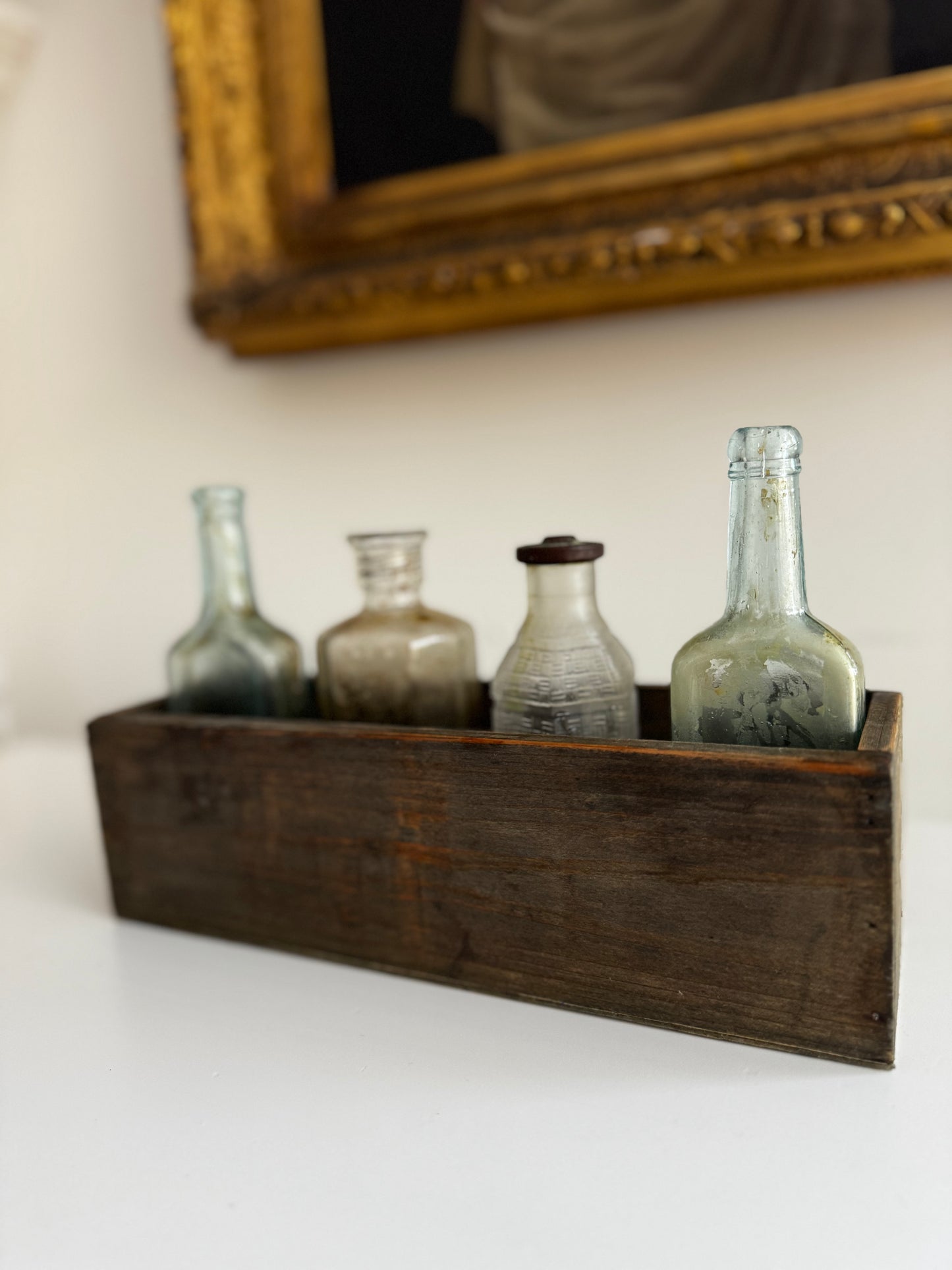 Antique Apothecary Bottle Collection In Vintage Wooden Trough