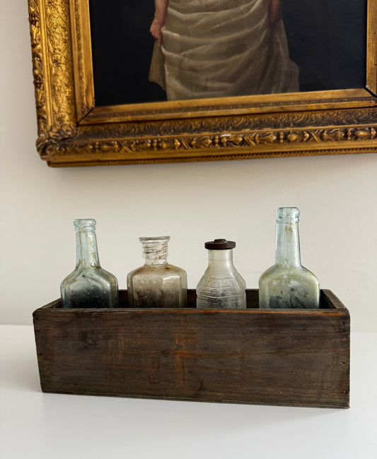 Antique Apothecary Bottle Collection In Vintage Wooden Trough